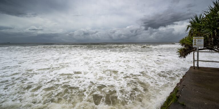 foamy sore dark cloudy skies alexandra headland beach queensland australia